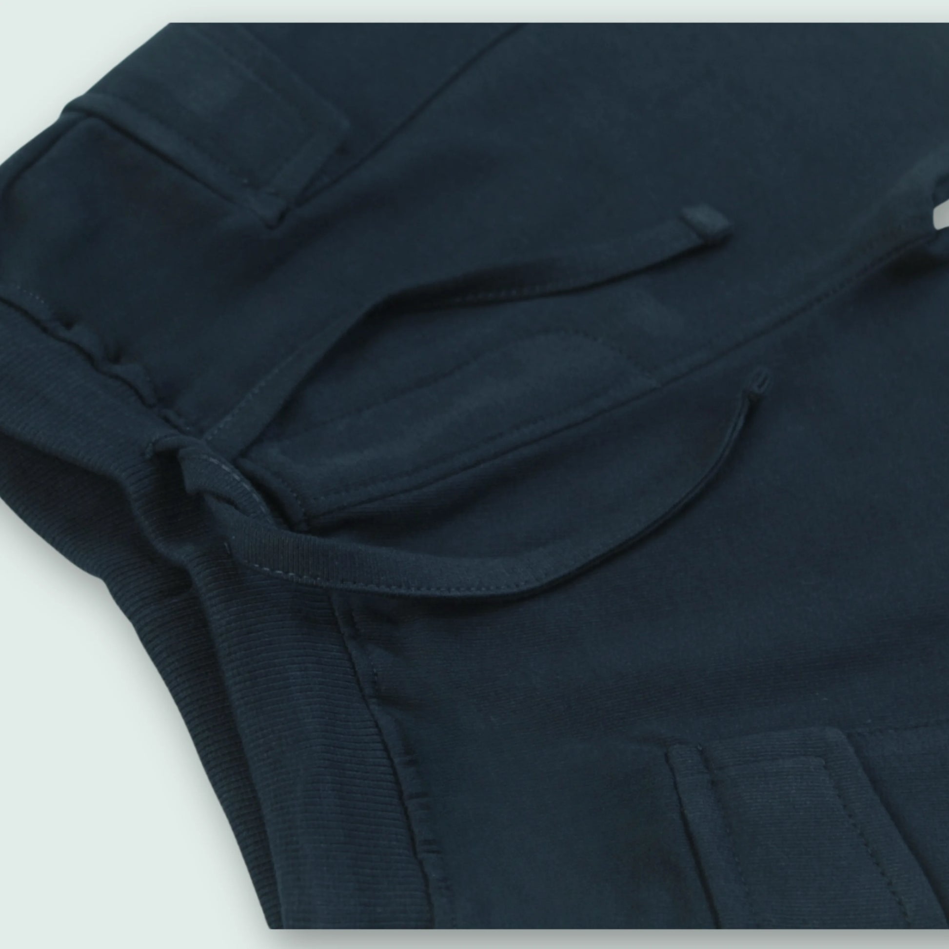 Close-up of elastic waistband on navy cotton shorts – comfortable and secure fit baby clothes for boys from Littleseeds™