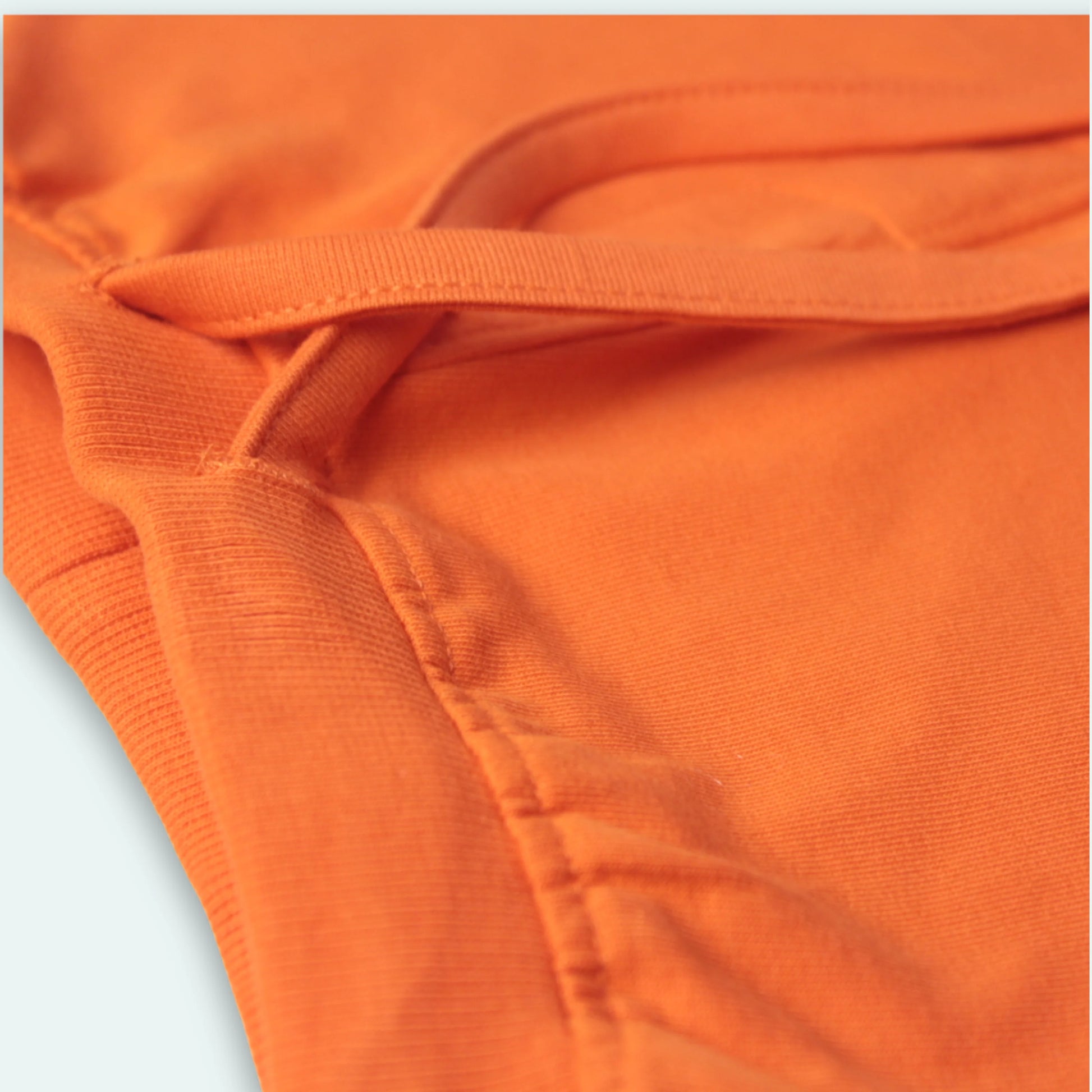 Elastic waistband detail of orange cotton shorts – soft stretch fit and easy to wear baby clothes for boys