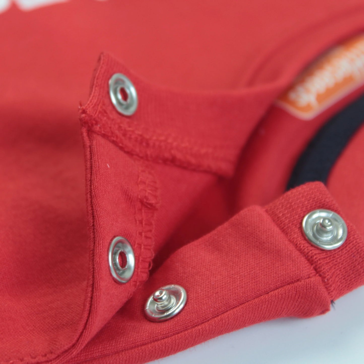 Close-up view of childrens t shirt in red showing cute panda print and premium cotton fabric quality for infants