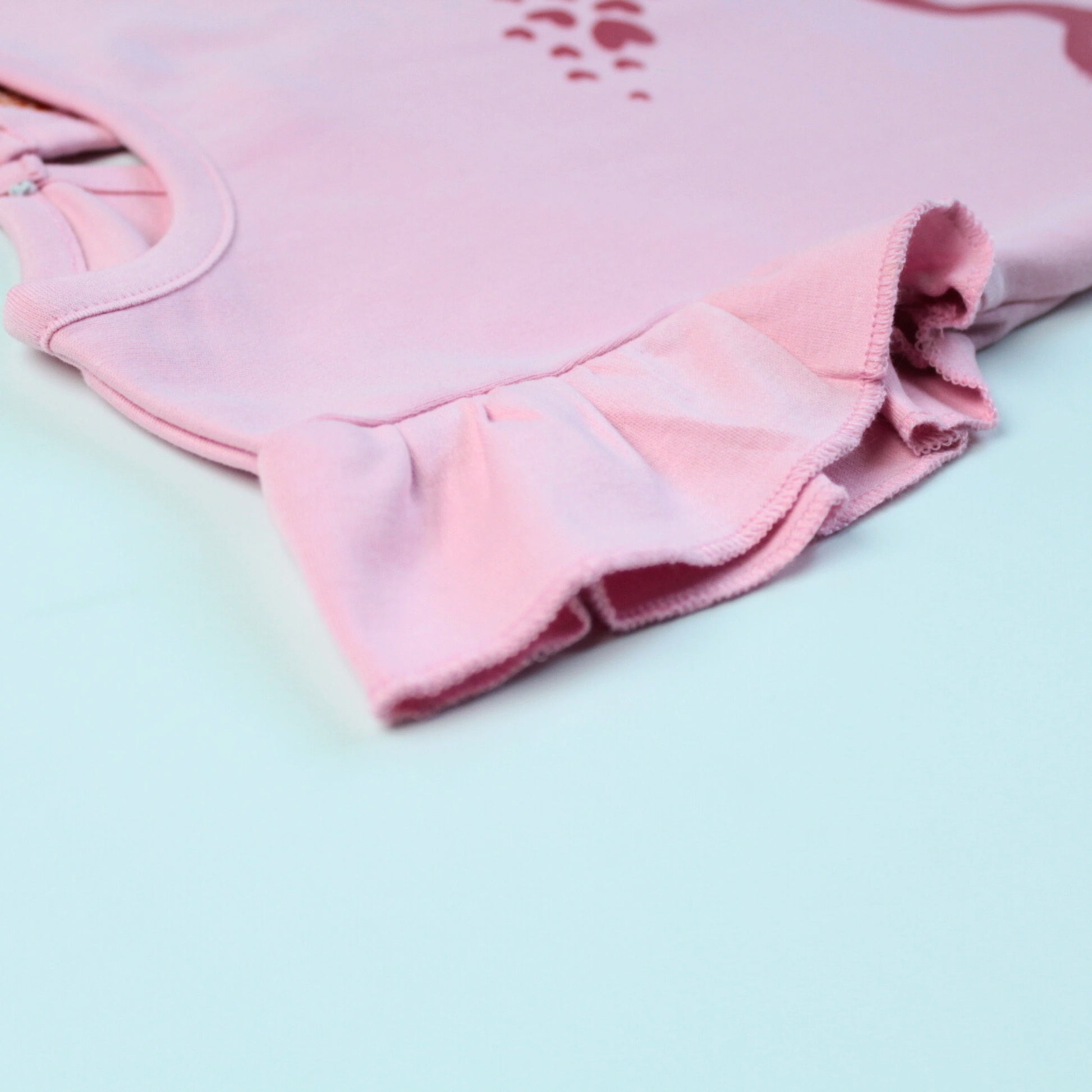 Detailed view highlighting soft cotton texture, stitching, and sleeve design of a pink frill T-shirt — quality girlish outfit for kids