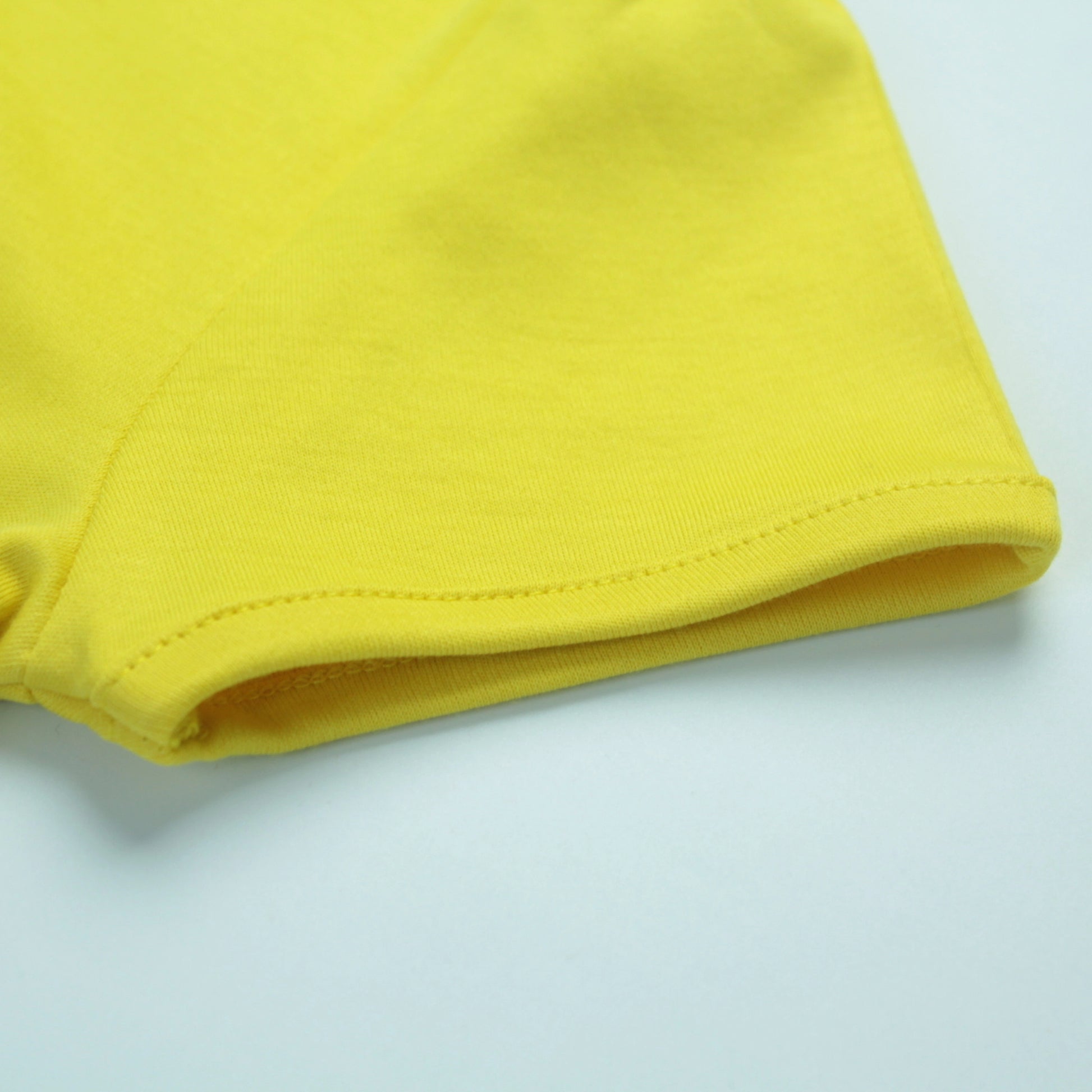 Detailed view of cotton fabric and stitching on yellow fairy print T-shirt – high-quality, durable girlish outfits by Littleseeds.