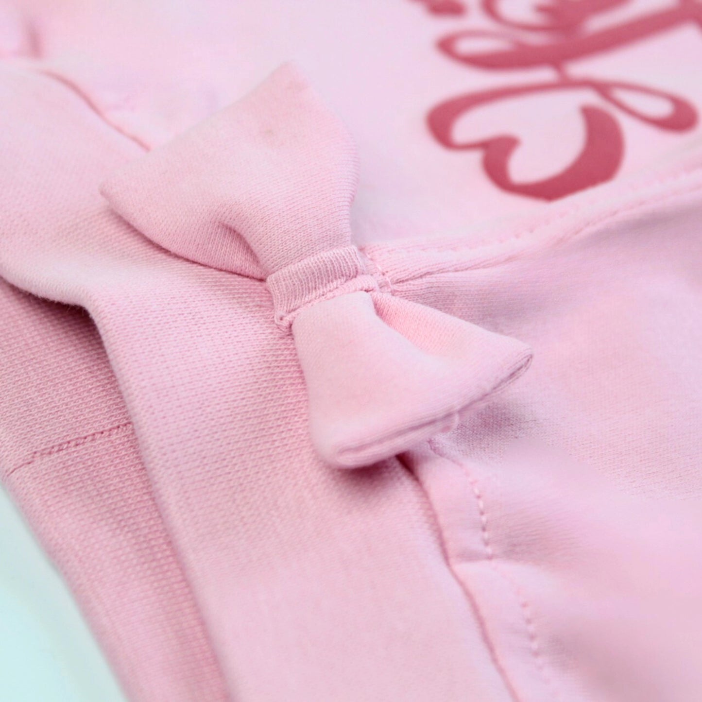 Detailed view of stitching and soft cotton fabric on pink girls joggers – durable and comfortable design