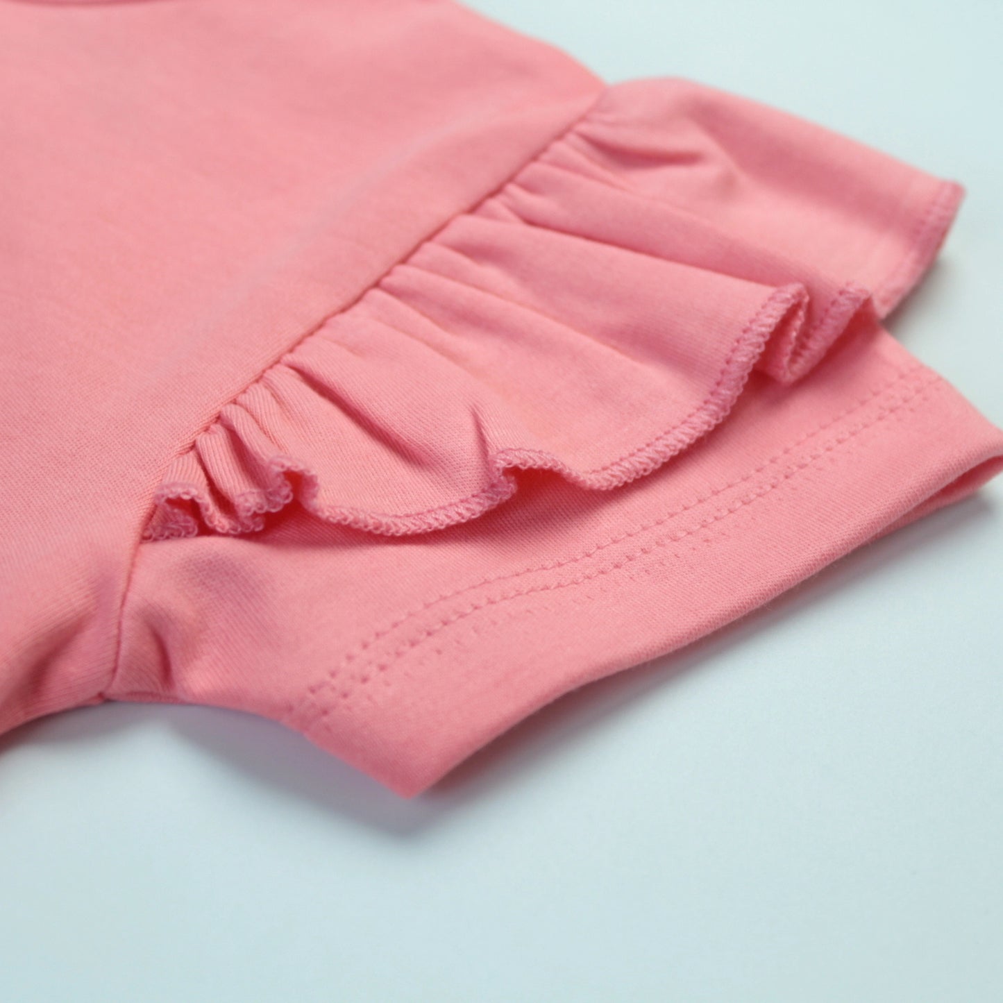 Detailed view of fabric texture and stitching quality on pink rabbit T-shirt – premium quality kiddies wears.