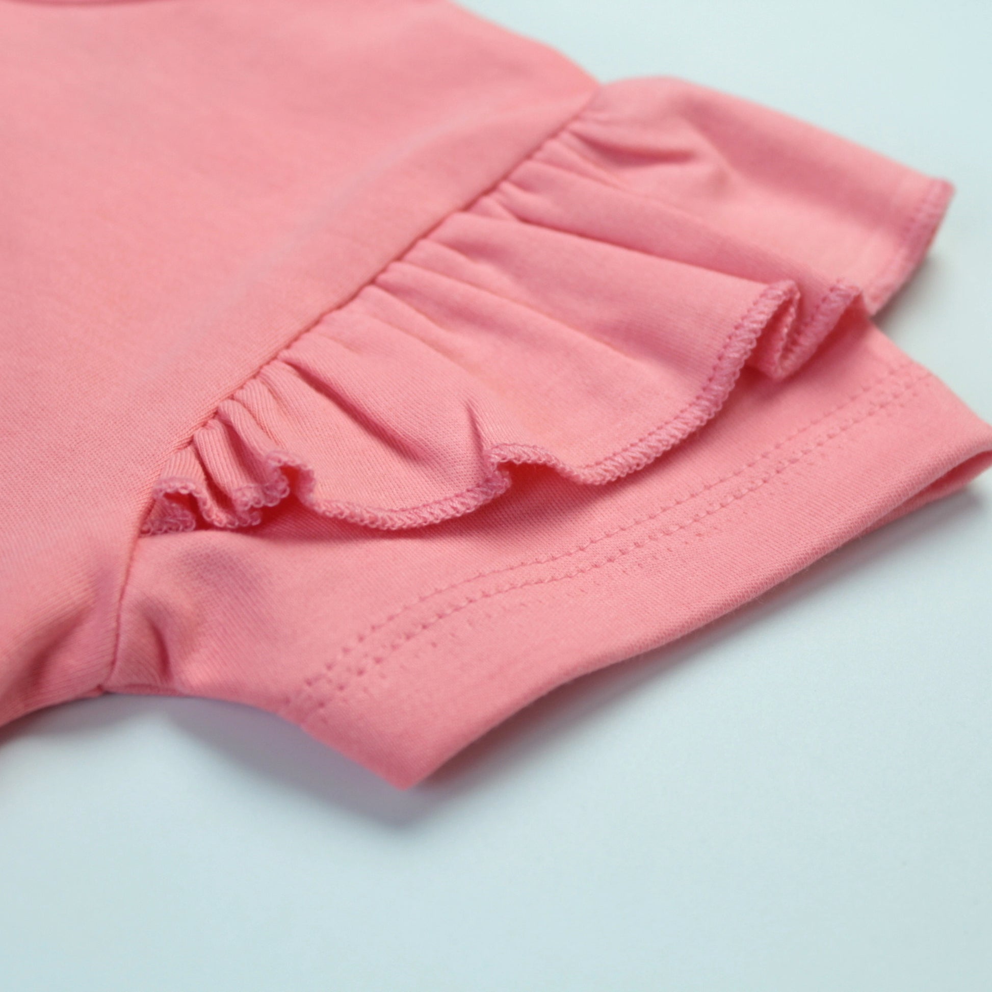 Detailed view of fabric texture and stitching quality on pink rabbit T-shirt – premium quality kiddies wears.