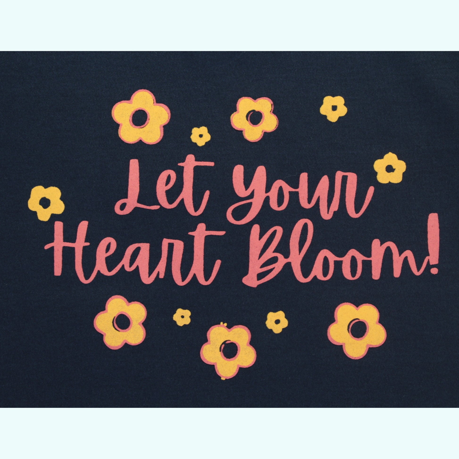 Close-up of floral placement print on navy cotton T-shirt – stylish and high-quality ladki dress design.