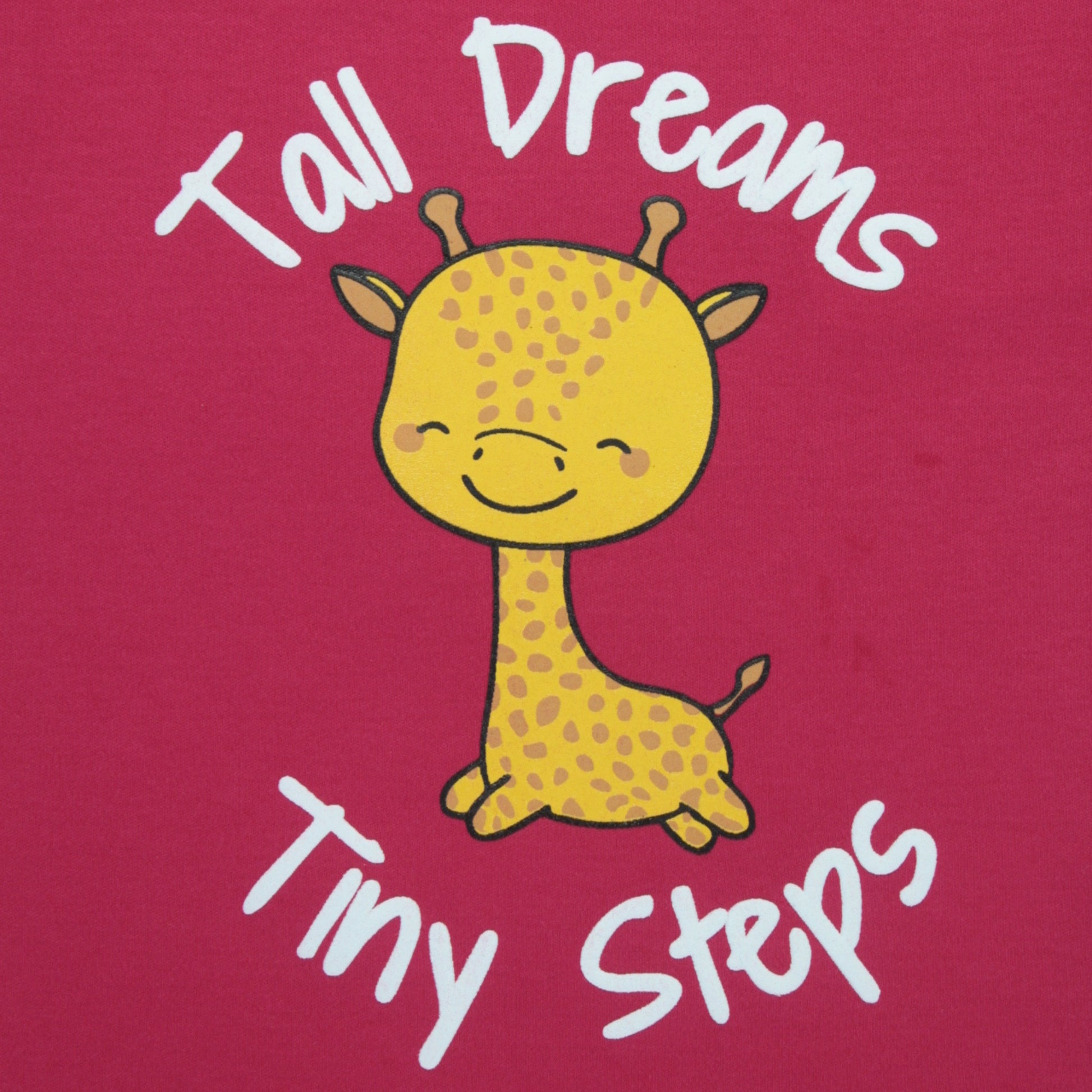 Close-up detail of giraffe print on dark pink cotton T-shirt – fun and eye-catching night dress for childrens.