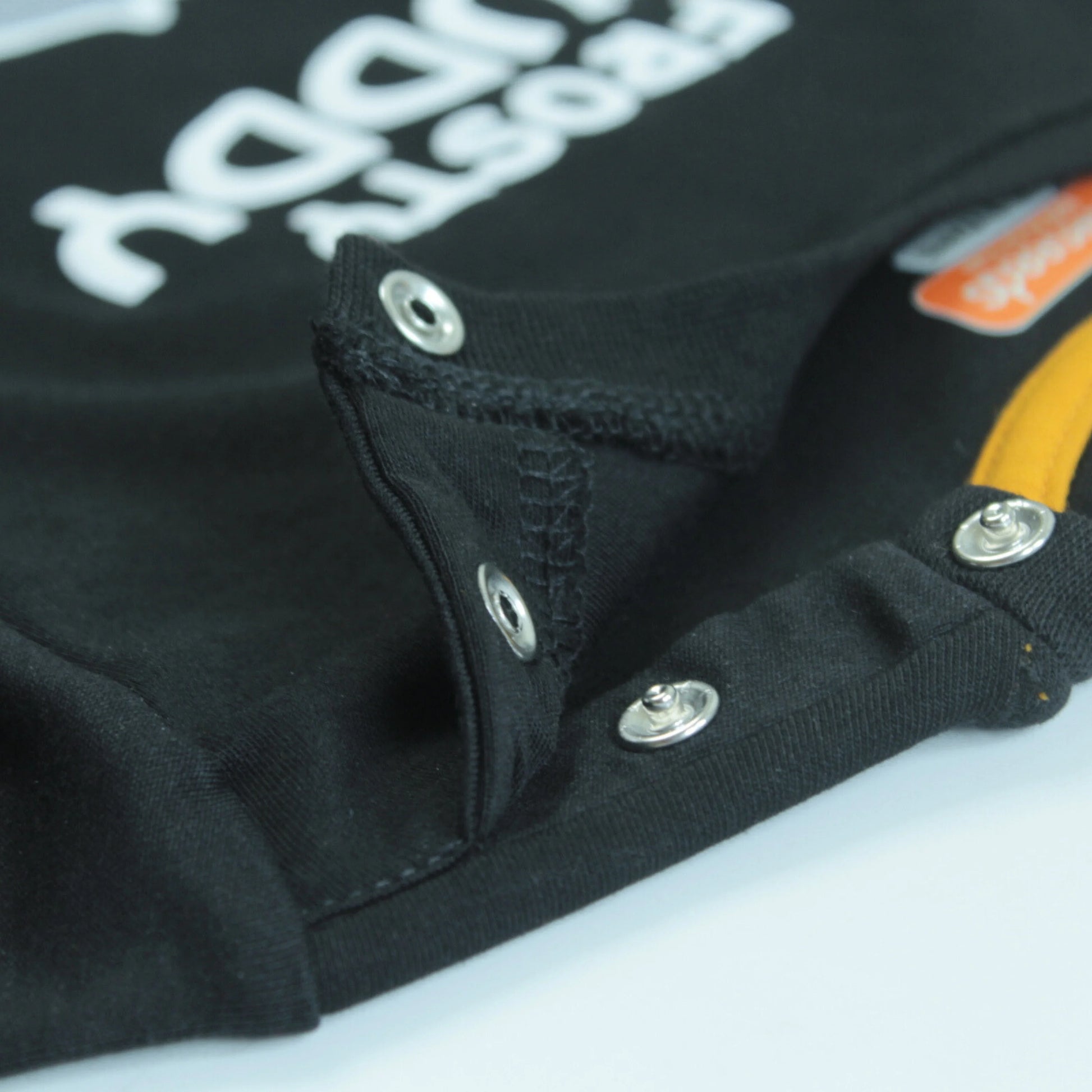 Detailed close-up of boys cotton childrens T-shirt in black with adorable penguin placement print – breathable fabric and premium stitching