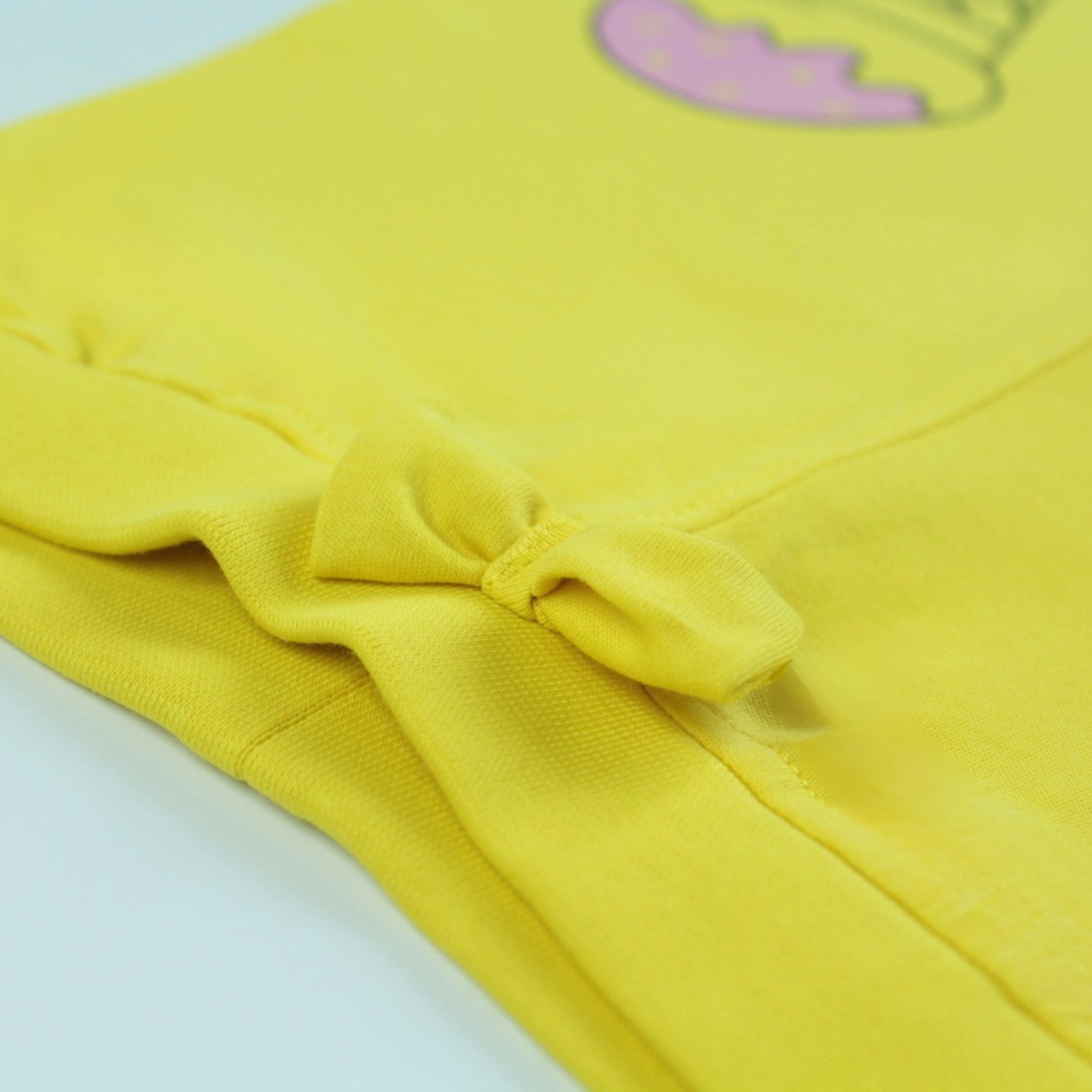 Close-up of waistband and fabric texture on yellow cotton jogger pants – soft and durable girlish outfits nightwear.