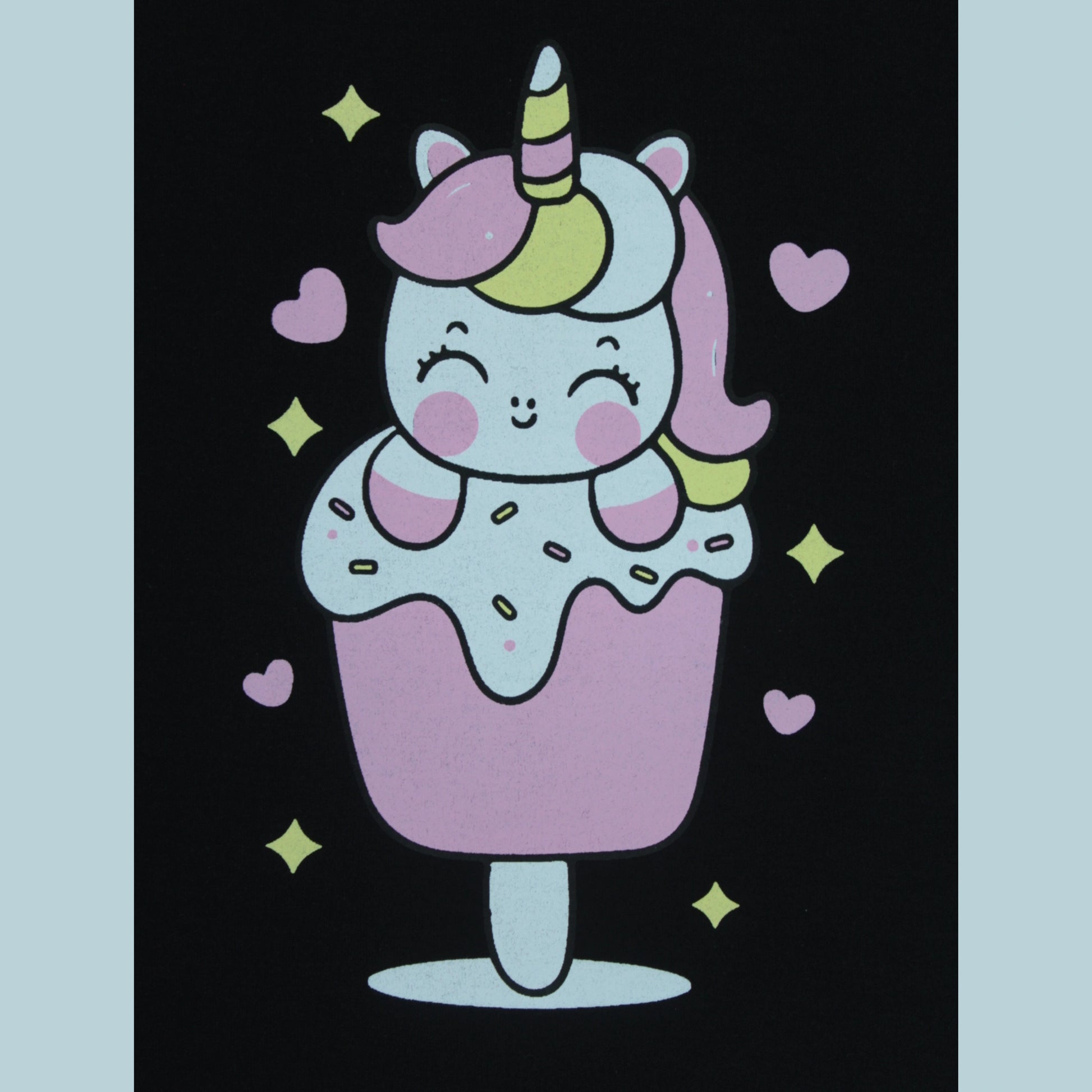 Close-up view of unicorn print on black puff sleeve T-shirt – playful and cute detail from latest girlish dresses collection.