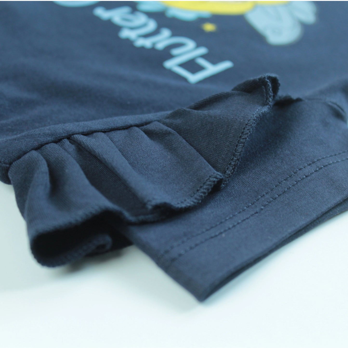 Detailed view of soft cotton fabric and sleeve stitching on navy half sleeve T-shirt – comfortable nightwear from latest girlish dresses.