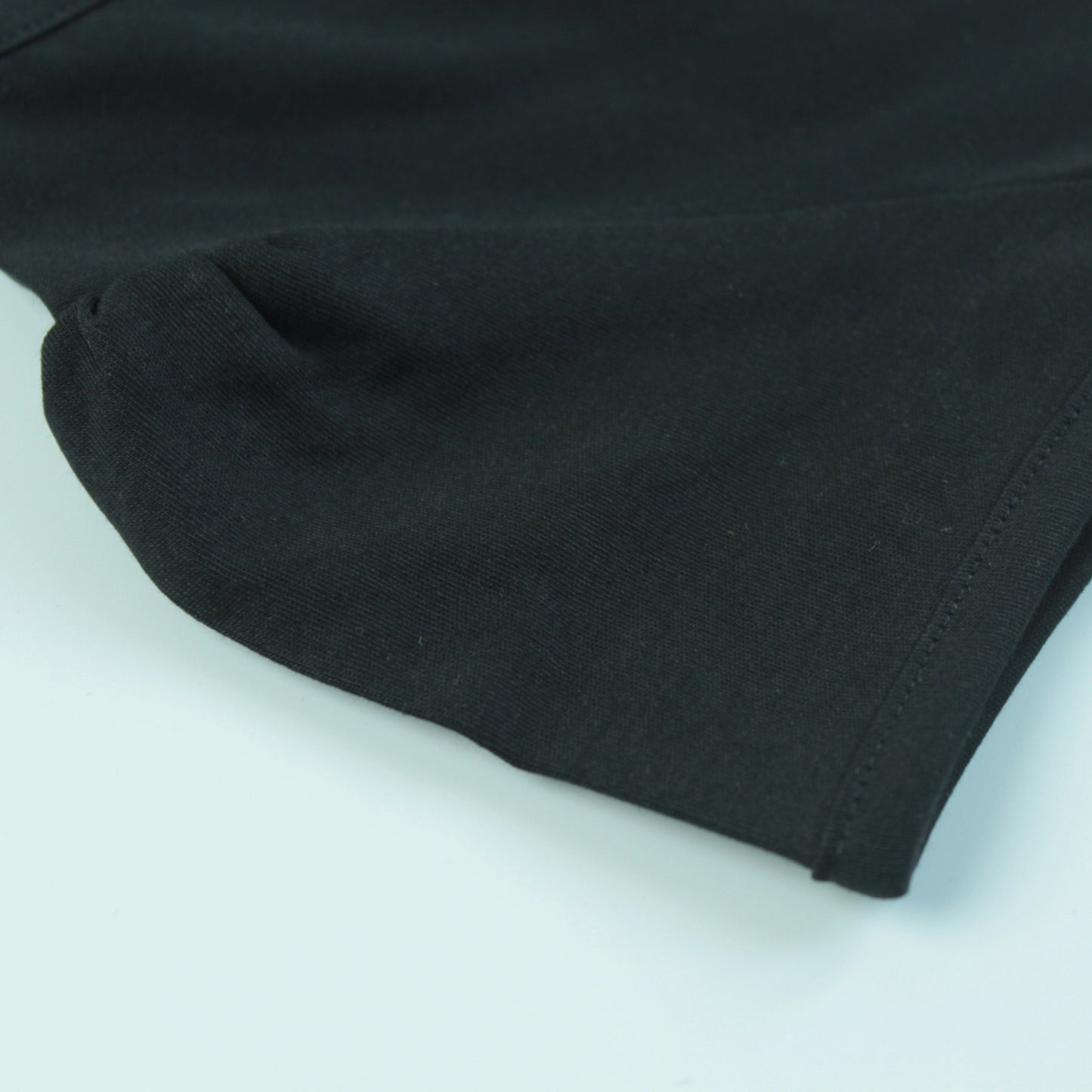 Detailed view of fabric and puff sleeve stitching on black cotton night T-shirt – soft and durable night dress for childrens.